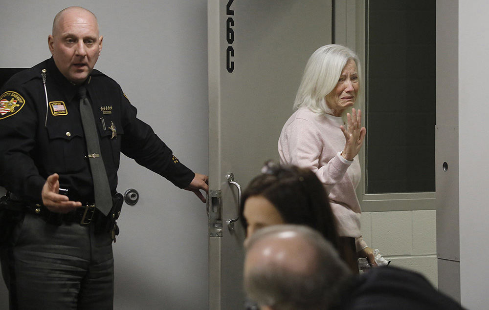 General News - 1st place   - Logan County Sheriff Deputy Jeff Anspach (left) escorts Rosalie Kennedy out of the courtroom after she was sentenced to 15 years to life, plus 3 years, for for killing her longtime husband after a night of drinking earlier this year She maintains she didn't shoot him; that they were both drunk and he pulled a gun and it went off. Rosalie maintained her innocence during the sentencing. (Tom Dodge / The Columbus Dispatch)